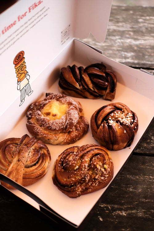 FIKA FIVE, an assorted box of 5 Swedish buns including cinnamon, cardamom, sun, chocolate, and almond varieties